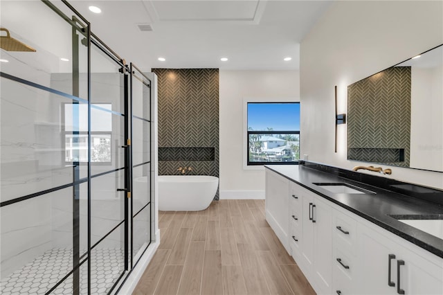 bathroom with vanity and independent shower and bath
