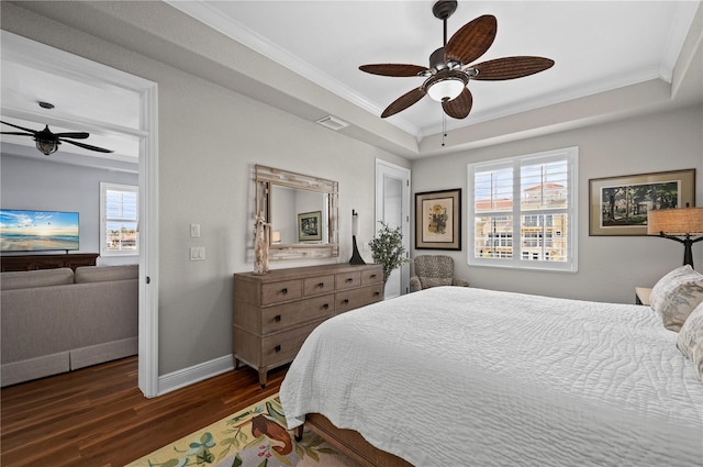 bedroom featuring crown molding, ceiling fan, dark hardwood / wood-style flooring, and a raised ceiling