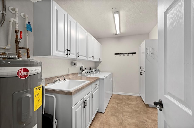 washroom featuring water heater, separate washer and dryer, sink, cabinets, and a textured ceiling