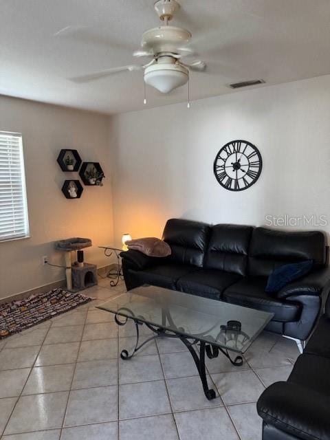 living room with light tile patterned floors, ceiling fan, and visible vents