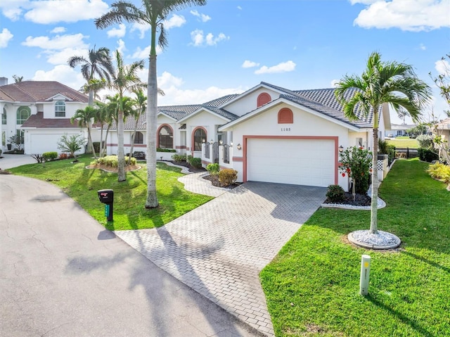 view of front of home featuring a garage and a front yard