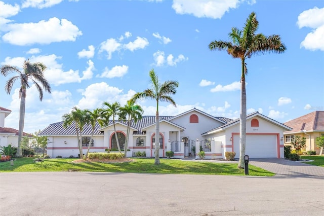 view of front facade with a garage and a front lawn