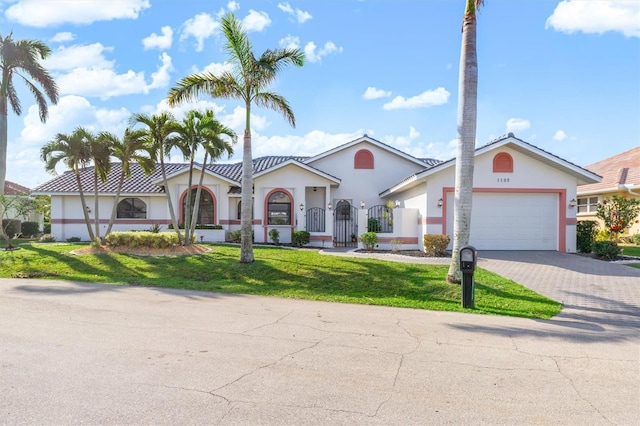 view of front of home featuring a garage and a front lawn