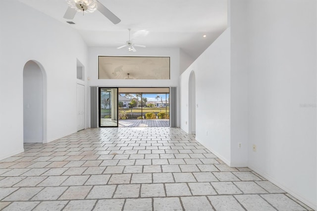 empty room with a high ceiling and ceiling fan