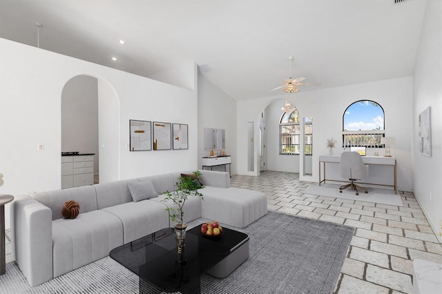 living room featuring high vaulted ceiling and ceiling fan