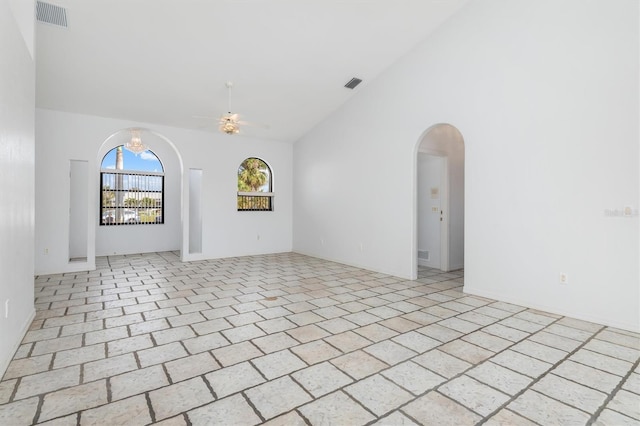 unfurnished room with high vaulted ceiling and ceiling fan