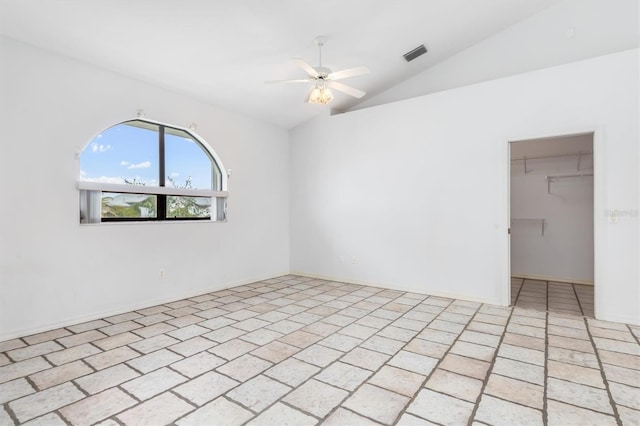 empty room featuring lofted ceiling and ceiling fan