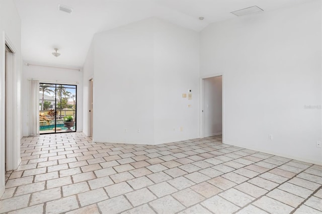 empty room featuring high vaulted ceiling