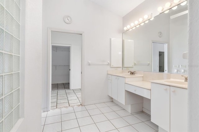 bathroom featuring lofted ceiling, tile patterned floors, and vanity