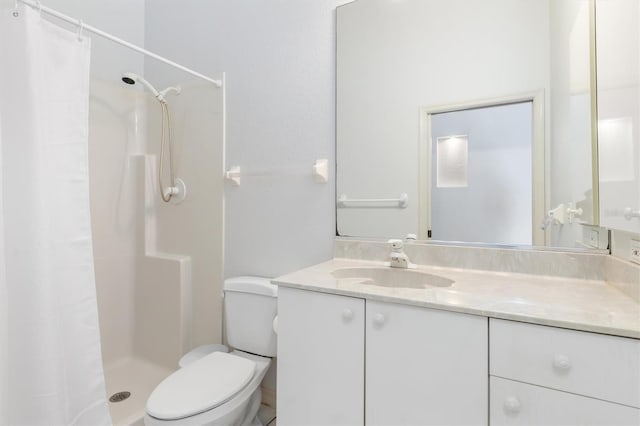 bathroom with vanity, curtained shower, and toilet