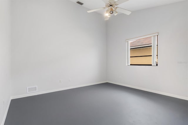 spare room featuring ceiling fan and concrete floors