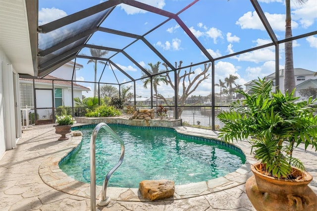 view of swimming pool with pool water feature, a patio, a water view, and glass enclosure