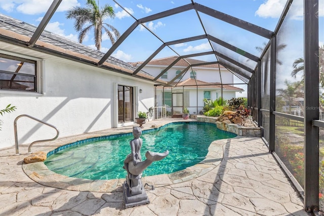 view of swimming pool featuring a lanai and a patio area