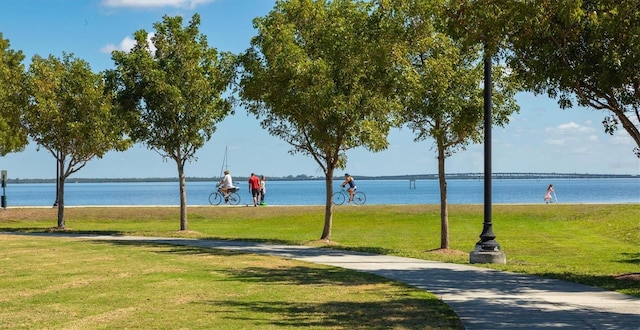 view of property's community featuring a water view and a lawn