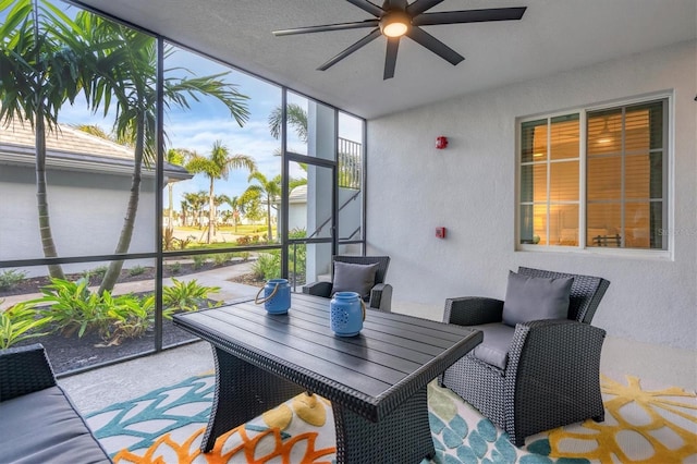 sunroom featuring a ceiling fan