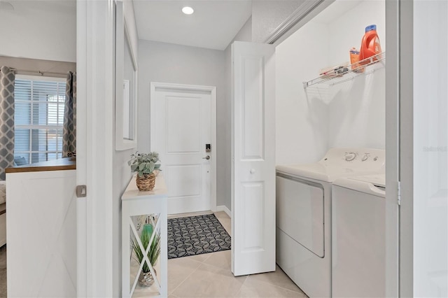 washroom featuring laundry area, washer and dryer, and light tile patterned floors