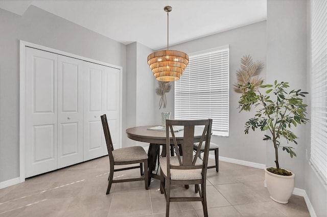 dining room with baseboards and light tile patterned floors