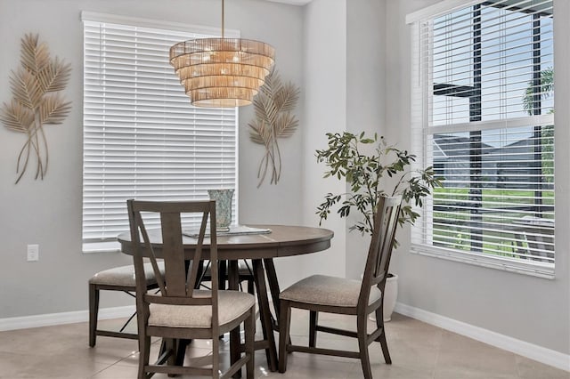 dining room featuring baseboards and light tile patterned floors