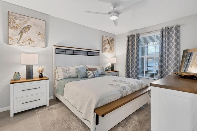 bedroom with ceiling fan, baseboards, and light tile patterned floors