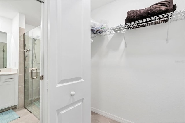 spacious closet with light tile patterned floors