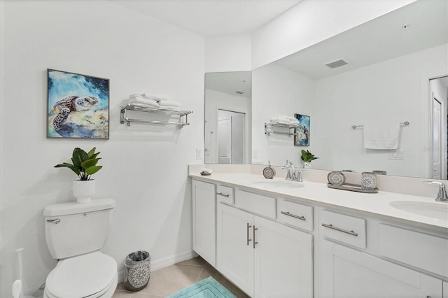 full bath with double vanity, a sink, and tile patterned flooring