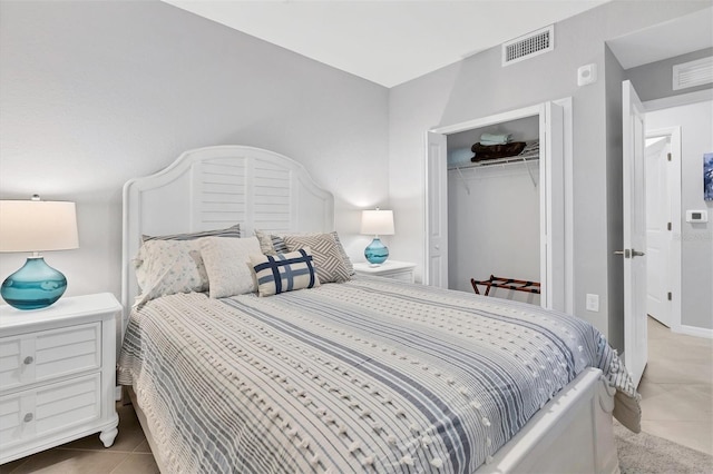 bedroom featuring visible vents, a closet, and light tile patterned flooring