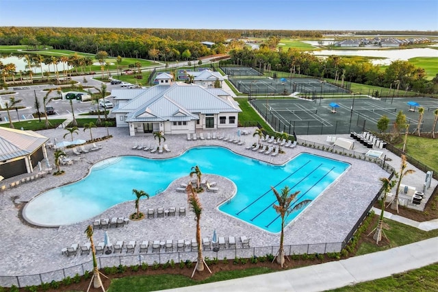 community pool featuring fence and a patio