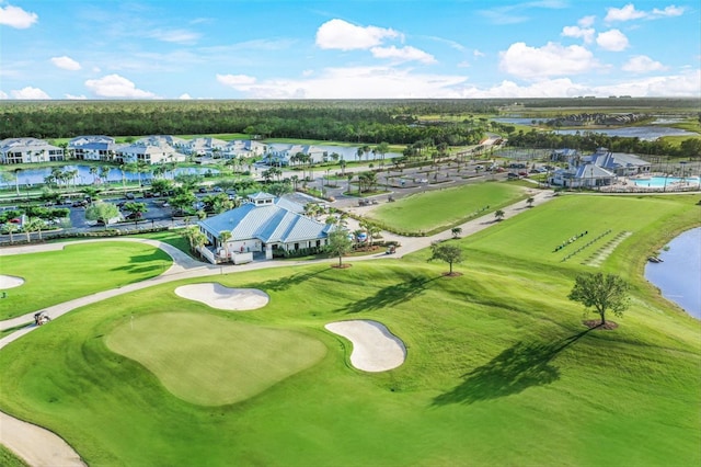 aerial view with a residential view, a water view, and golf course view