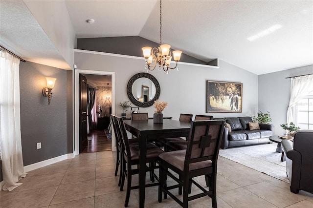 tiled dining room with lofted ceiling and a notable chandelier