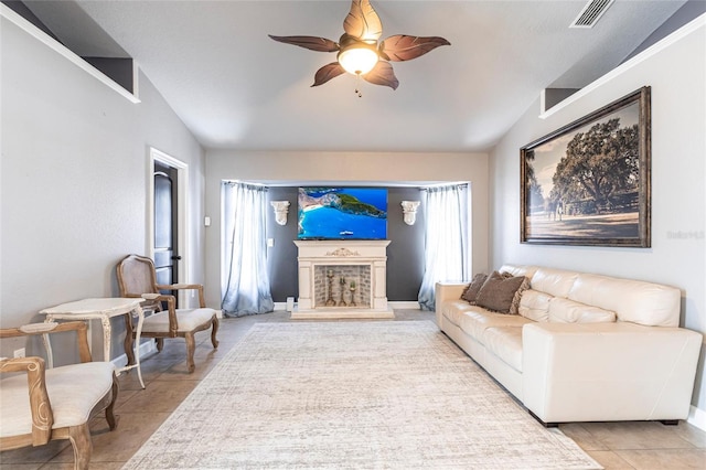 tiled living room featuring a healthy amount of sunlight, ceiling fan, and lofted ceiling