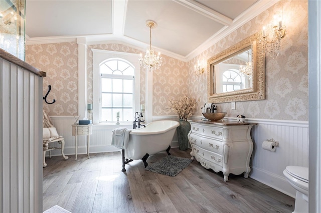 bathroom with lofted ceiling, vanity, a bath, wood-type flooring, and toilet