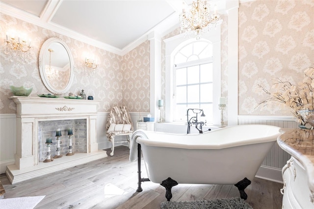 bathroom with hardwood / wood-style flooring, crown molding, and a tub to relax in