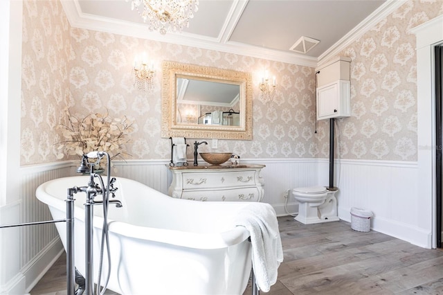 bathroom with hardwood / wood-style flooring, a chandelier, toilet, and a bathing tub