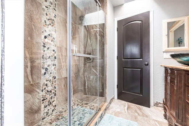 bathroom featuring vanity and a shower with shower door