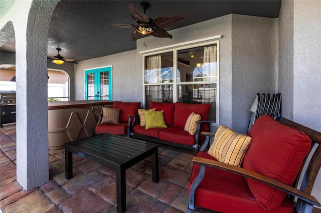 view of patio with an outdoor living space and ceiling fan