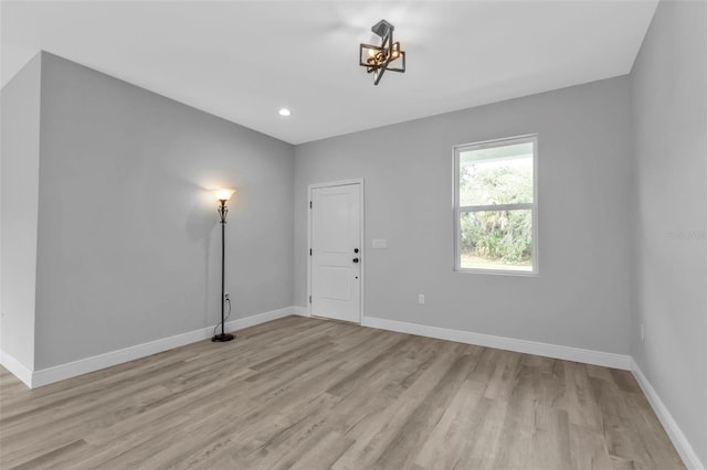 unfurnished room with light wood-type flooring