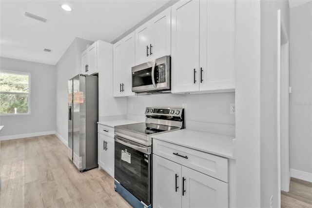 kitchen with white cabinetry, light hardwood / wood-style flooring, and stainless steel appliances