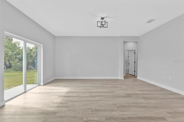 unfurnished room with light wood-type flooring and a wealth of natural light