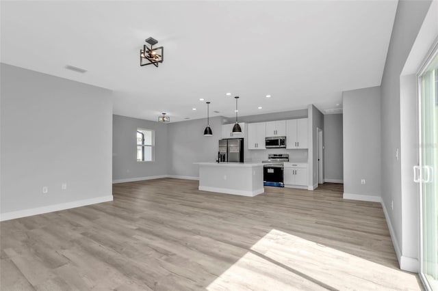 unfurnished living room with light hardwood / wood-style floors