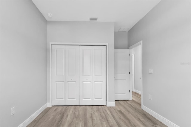 unfurnished bedroom with light hardwood / wood-style floors and a closet