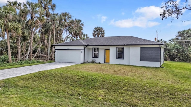 view of front of home with a garage and a front lawn