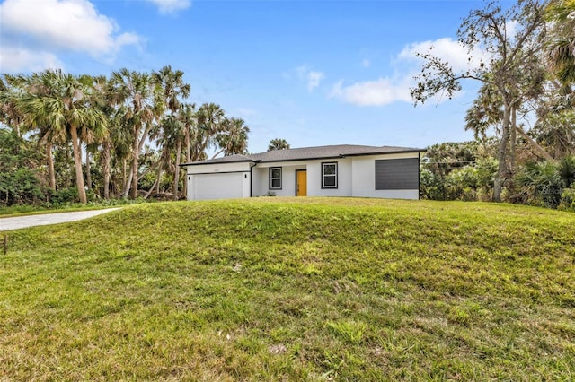 ranch-style house featuring a garage and a front lawn