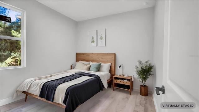 bedroom with light hardwood / wood-style floors