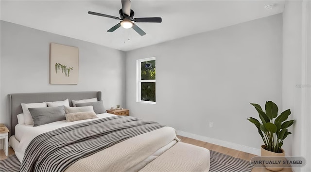 bedroom featuring hardwood / wood-style floors and ceiling fan