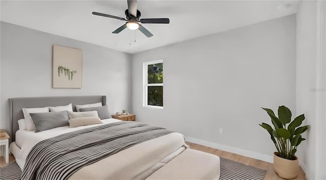 bedroom with hardwood / wood-style floors and ceiling fan