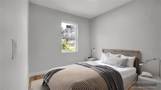 bedroom with hardwood / wood-style floors