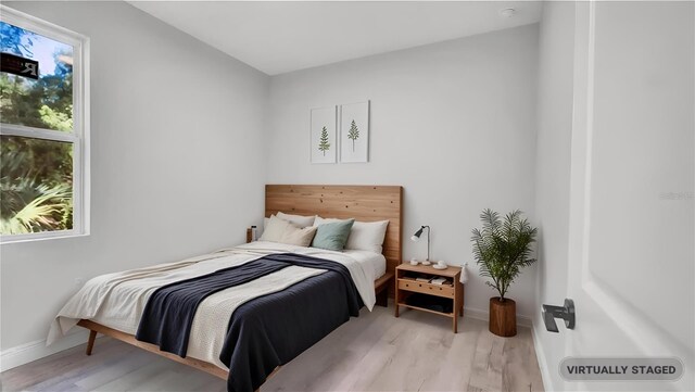 1117 Vernon Ave, Port Charlotte, FL 33948 - bedroom featuring light wood-style floors and baseboards