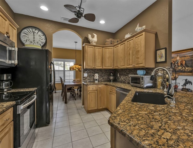 kitchen featuring decorative backsplash, a ceiling fan, a sink, light tile patterned floors, and stainless steel appliances