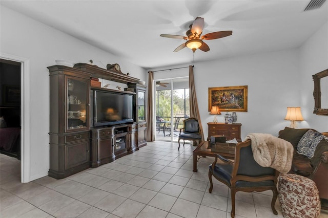 living room with a ceiling fan, visible vents, and light tile patterned flooring