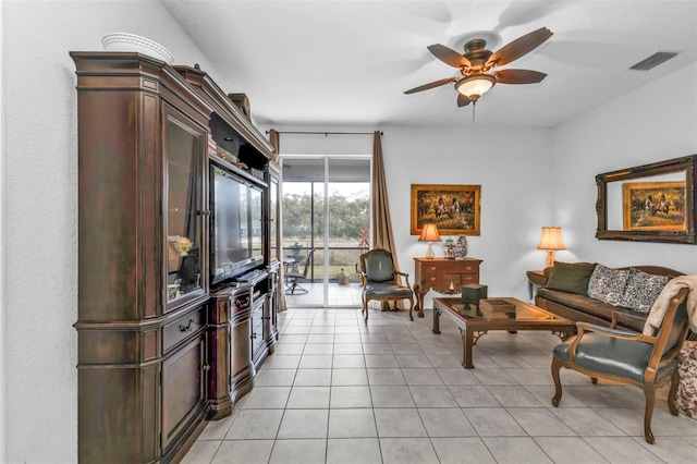 living area with light tile patterned floors, ceiling fan, and visible vents